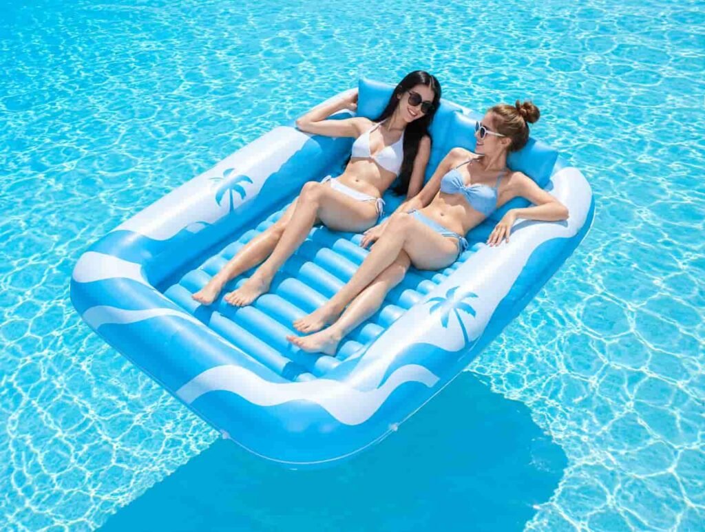 Blue rectangular inflatable tanning pool lounger with removable pillow