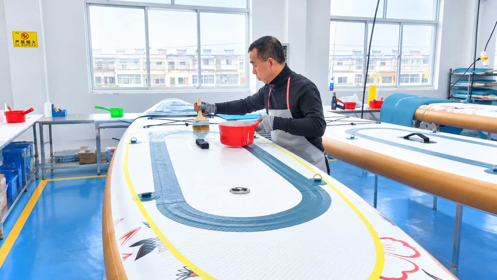 EVA deck pad being bonded onto an inflatable SUP board